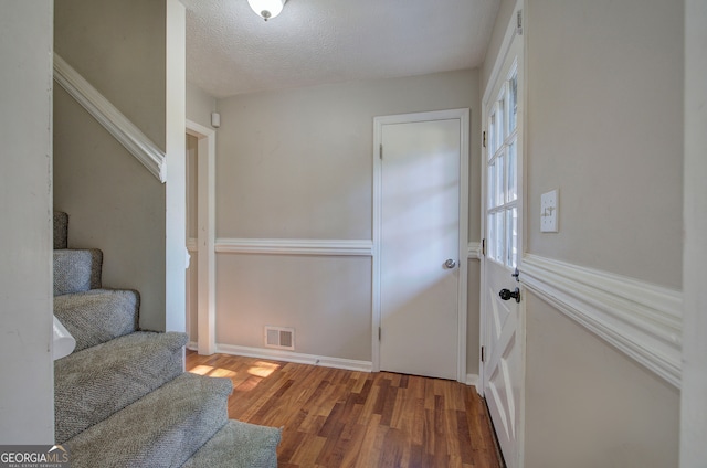 sitting room featuring wood-type flooring and a textured ceiling