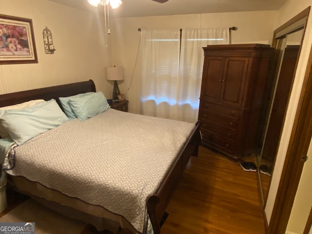 bedroom with dark hardwood / wood-style floors and ceiling fan