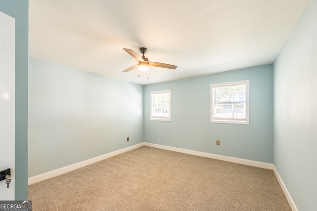 unfurnished room featuring ceiling fan and carpet floors