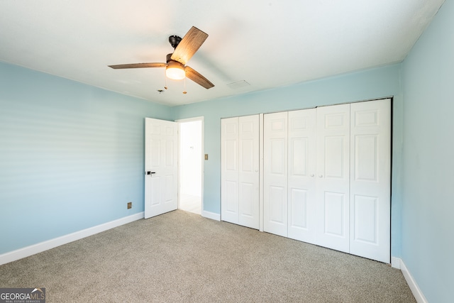 unfurnished bedroom with carpet floors, a closet, and ceiling fan