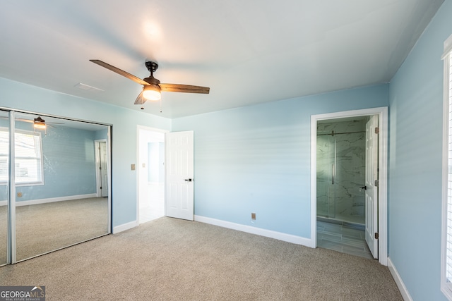 unfurnished bedroom featuring a closet, ceiling fan, ensuite bathroom, and light carpet