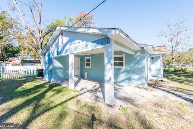 rear view of property featuring a yard