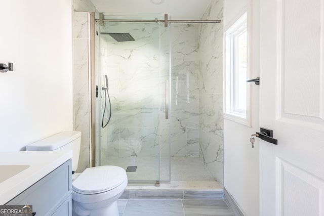 bathroom featuring vanity, toilet, and walk in shower