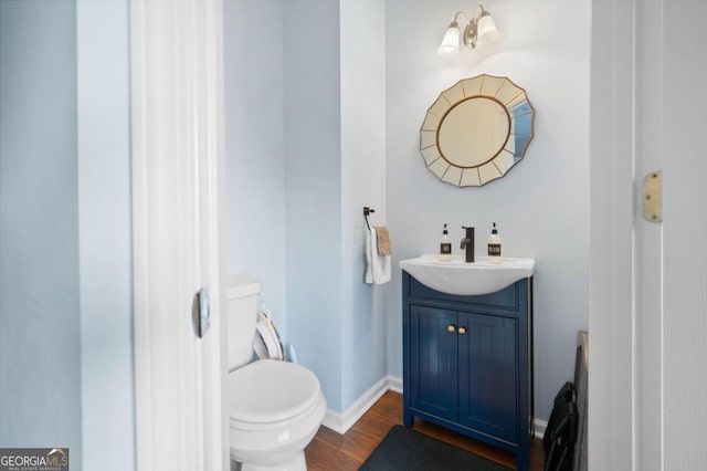 bathroom featuring hardwood / wood-style floors, vanity, and toilet