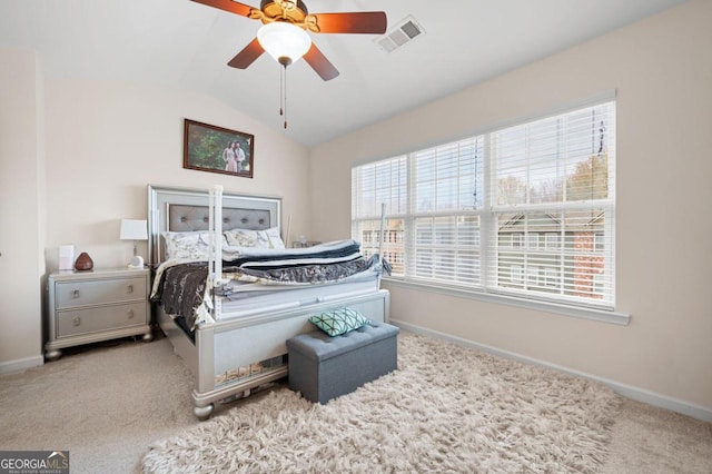 carpeted bedroom featuring multiple windows, ceiling fan, and vaulted ceiling