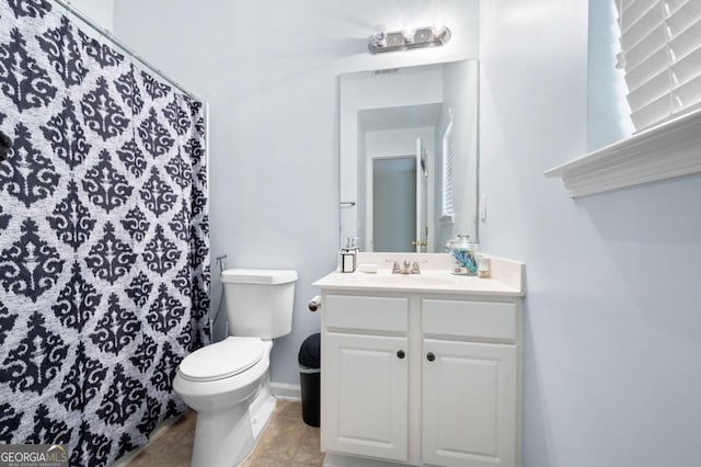 bathroom with tile patterned floors, vanity, and toilet