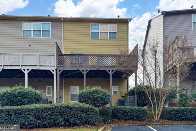 back of property with a wooden deck