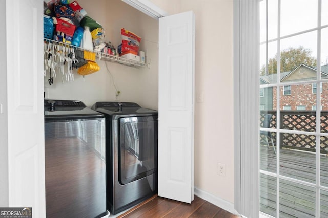 clothes washing area featuring dark hardwood / wood-style flooring and independent washer and dryer