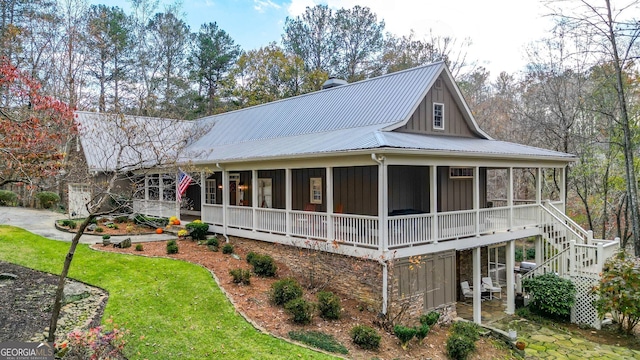 view of front facade with a sunroom and a front yard