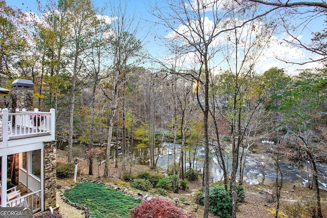 view of yard with a balcony and a water view