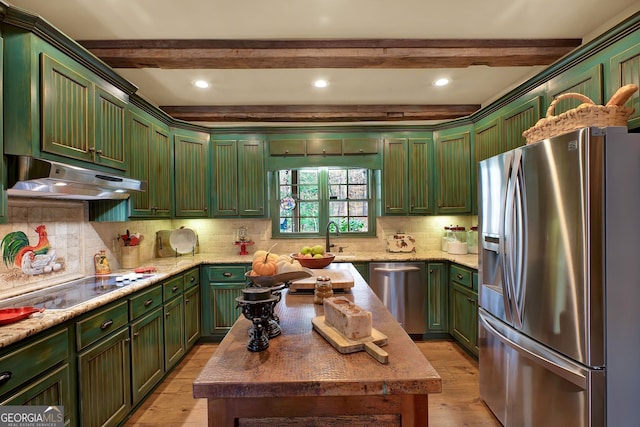 kitchen with tasteful backsplash, beamed ceiling, light wood-type flooring, and appliances with stainless steel finishes