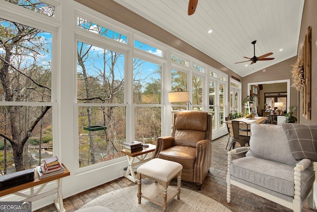 sunroom / solarium with ceiling fan, lofted ceiling, and wooden ceiling