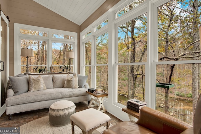 sunroom featuring plenty of natural light and lofted ceiling