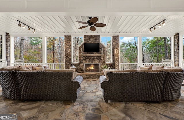 view of patio featuring an outdoor living space with a fireplace and ceiling fan