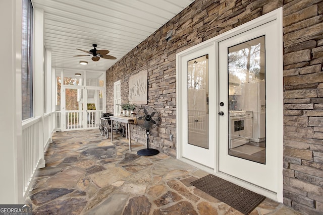 interior space with ceiling fan and french doors