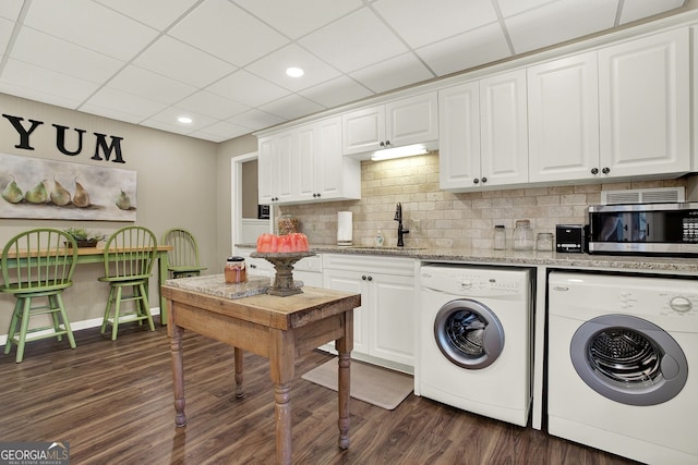 washroom with washer and dryer, dark hardwood / wood-style flooring, and sink