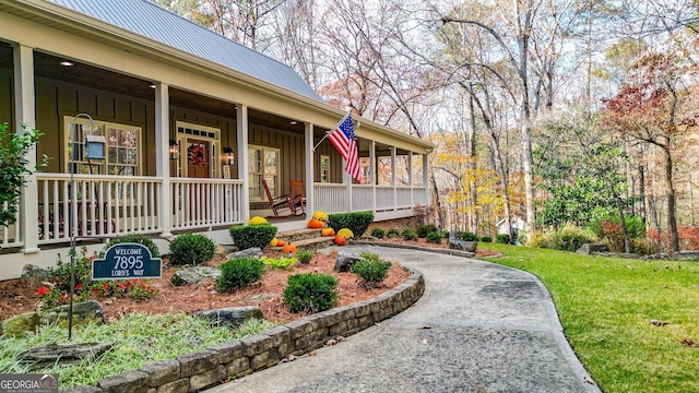 exterior space with a porch and a yard