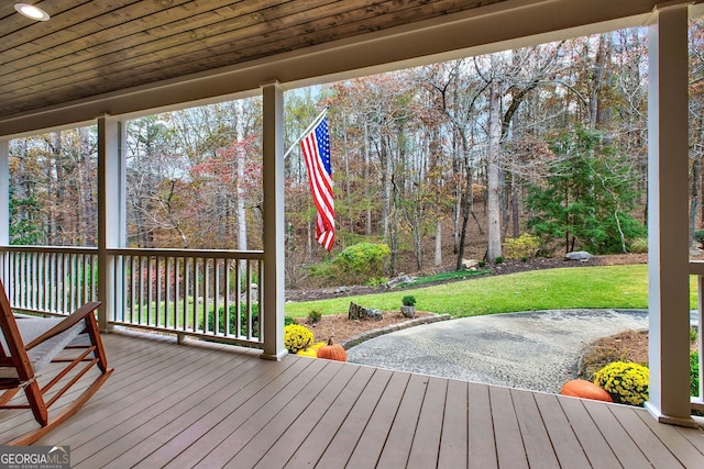 wooden terrace with a lawn