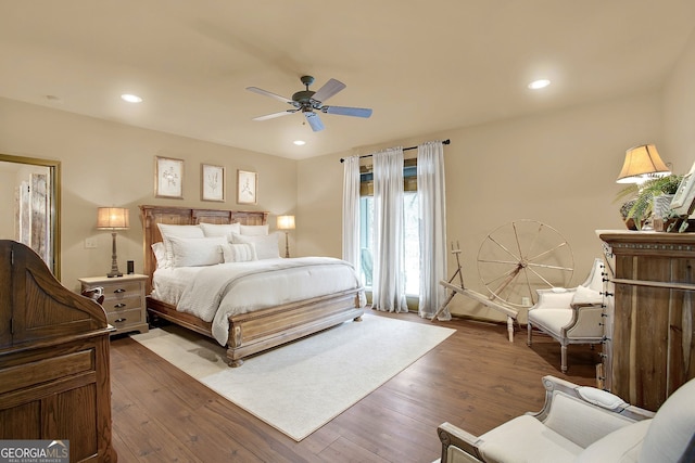 bedroom featuring ceiling fan and dark hardwood / wood-style floors