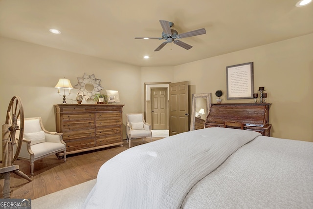 bedroom with hardwood / wood-style floors and ceiling fan