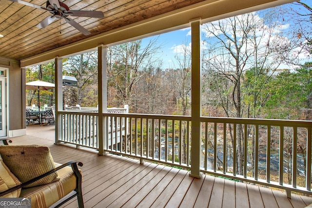 wooden terrace featuring ceiling fan