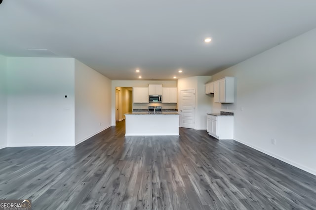 unfurnished living room featuring dark hardwood / wood-style floors