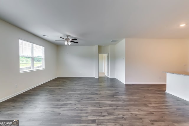 unfurnished living room with dark hardwood / wood-style floors and ceiling fan