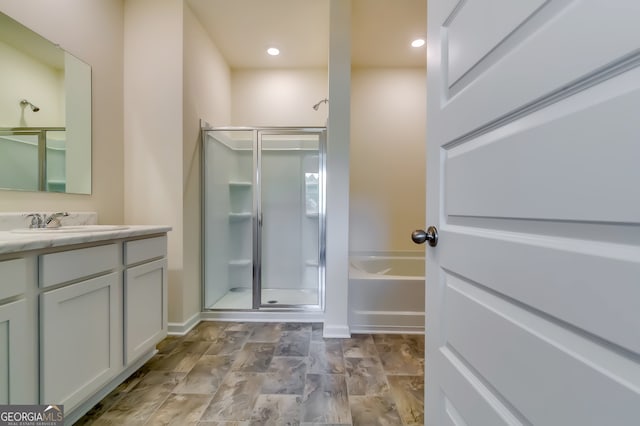 bathroom with vanity and plus walk in shower