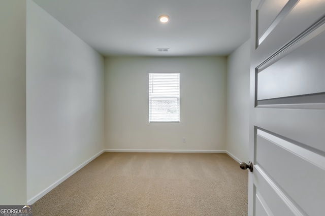 empty room featuring light colored carpet