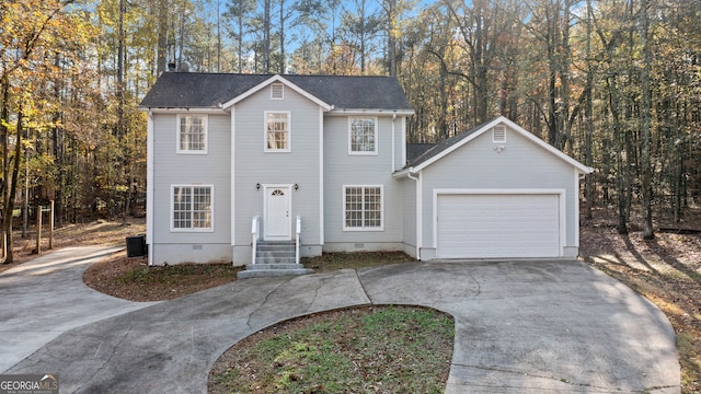 view of front of home featuring cooling unit and a garage