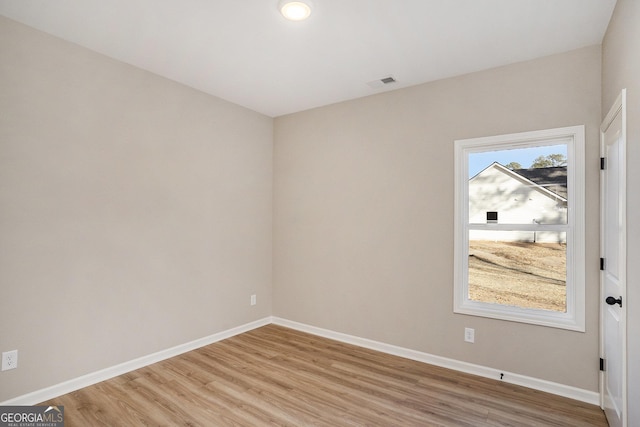 empty room with light hardwood / wood-style flooring