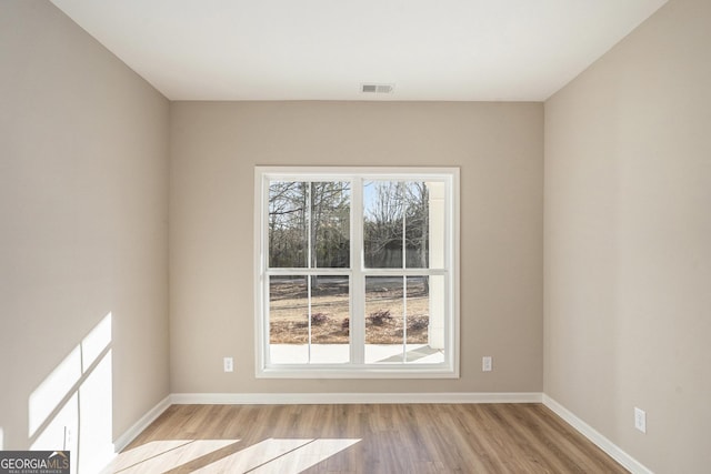 spare room featuring light hardwood / wood-style flooring