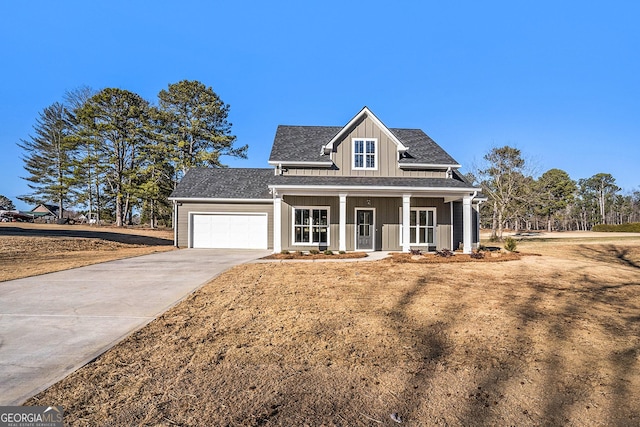 view of front facade featuring covered porch and a garage