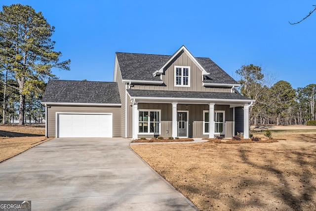 view of front of property with covered porch and a garage