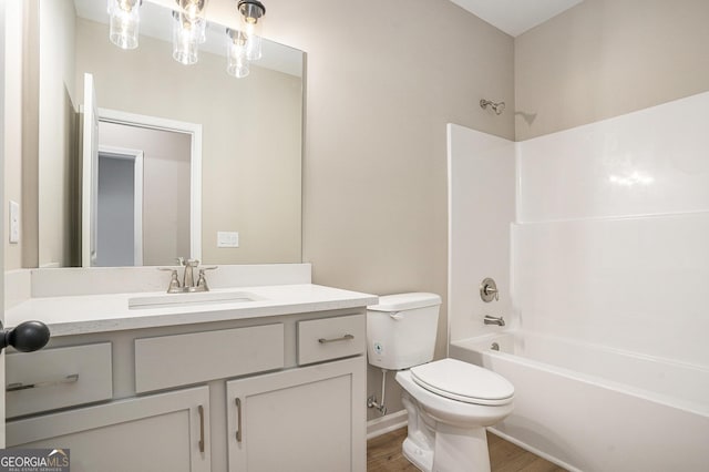 full bathroom featuring vanity, toilet, wood-type flooring, and bathtub / shower combination