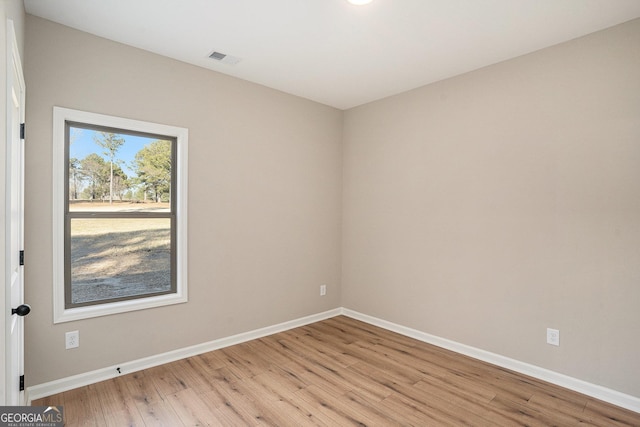 spare room featuring light wood-type flooring