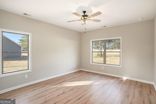 unfurnished room with light hardwood / wood-style flooring and ceiling fan