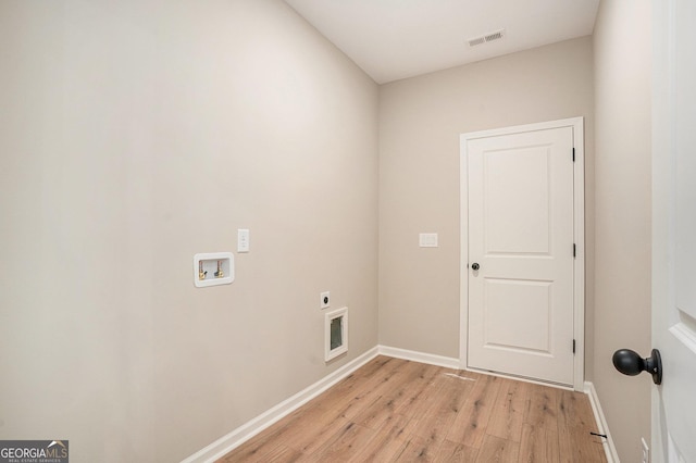 laundry room featuring hookup for a washing machine, light hardwood / wood-style flooring, and hookup for an electric dryer