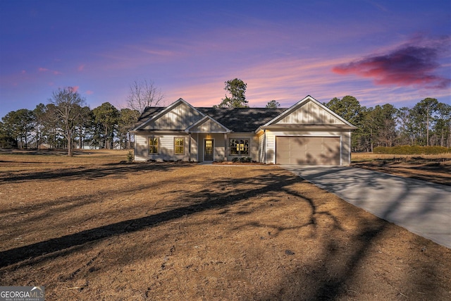 single story home featuring a garage and a lawn