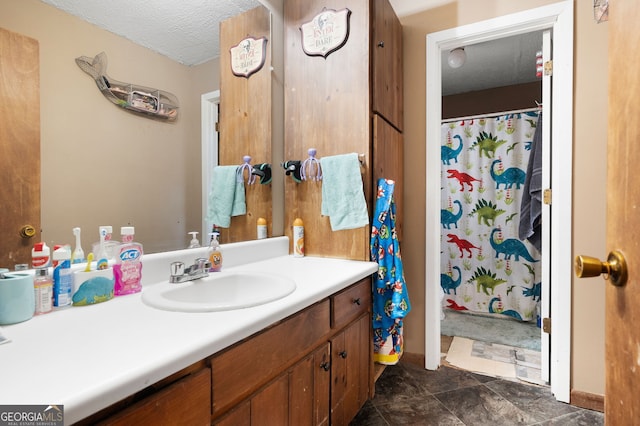 bathroom featuring a textured ceiling and vanity