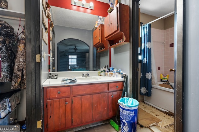 bathroom featuring shower / bath combo with shower curtain, vanity, and a textured ceiling