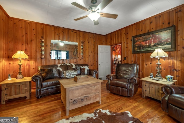 7667 Tallahassee Hwy, Attapulgus, GA 39815 - living room featuring a ceiling fan, wood walls, and wood finished floors