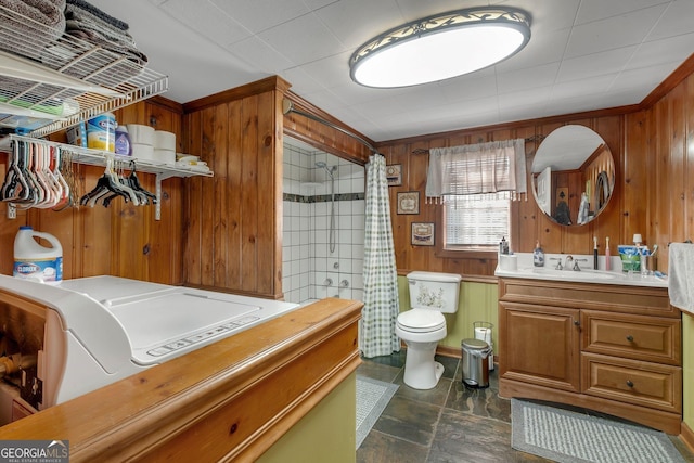 bathroom with vanity, toilet, walk in shower, and wood walls