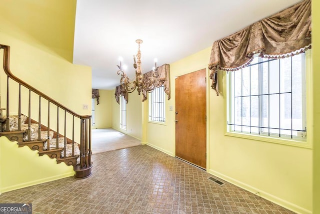 entryway featuring a chandelier