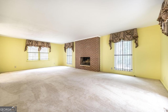 6909 Forsyth Rd, Macon, GA 31210 - unfurnished living room featuring carpet floors and a brick fireplace
