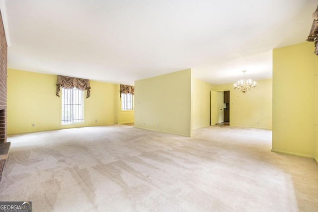 6909 Forsyth Rd, Macon, GA 31210 - unfurnished living room with a chandelier, a fireplace, and light colored carpet