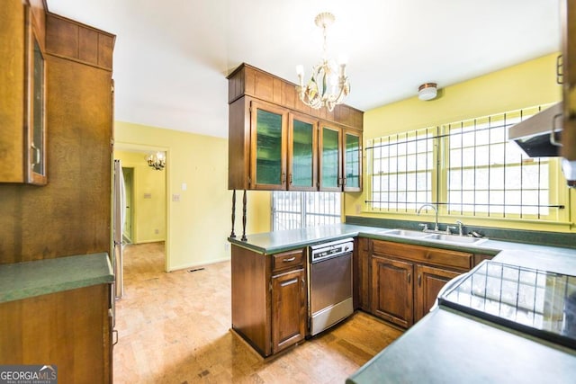 kitchen featuring pendant lighting, dishwasher, sink, light hardwood / wood-style flooring, and a chandelier