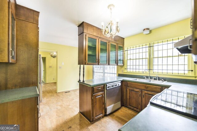 6909 Forsyth Rd, Macon, GA 31210 - kitchen with stainless steel dishwasher, a chandelier, under cabinet range hood, and light wood-style flooring