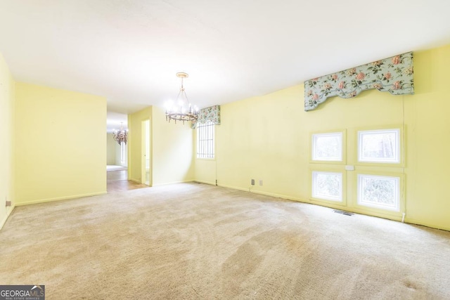 6909 Forsyth Rd, Macon, GA 31210 - carpeted empty room with a chandelier and baseboards