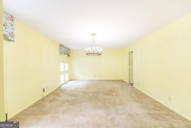 6909 Forsyth Rd, Macon, GA 31210 - spare room featuring a chandelier and light carpet